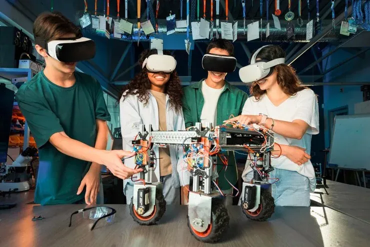 Students wearing VR headsets around a robot they built